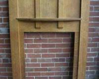 antique oak Arts and Crafts fire surround with carved details.